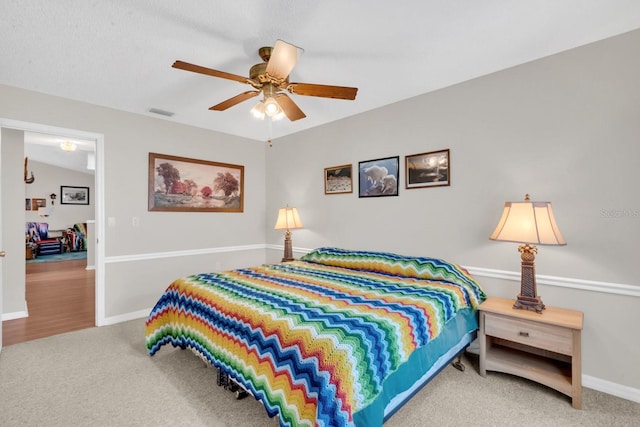 bedroom with carpet floors, vaulted ceiling, and ceiling fan