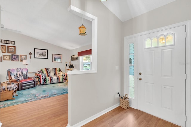 foyer with hardwood / wood-style flooring and lofted ceiling