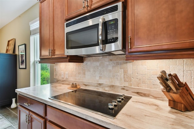 kitchen with backsplash and black electric cooktop