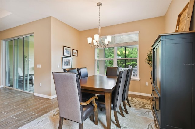 dining room featuring an inviting chandelier and light wood-type flooring