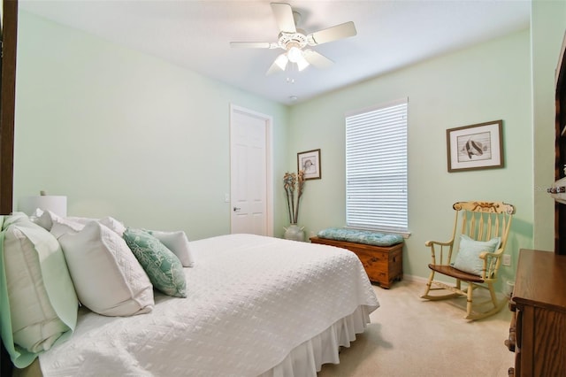 bedroom with a closet, light colored carpet, and ceiling fan