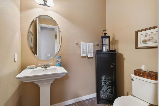 bathroom featuring hardwood / wood-style flooring and toilet