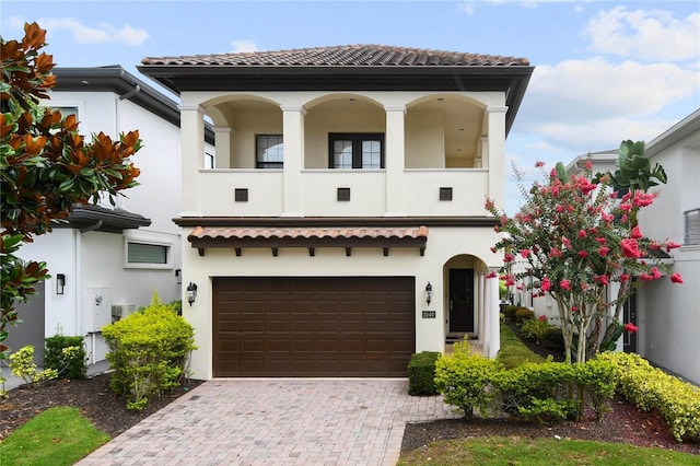 mediterranean / spanish house with a garage