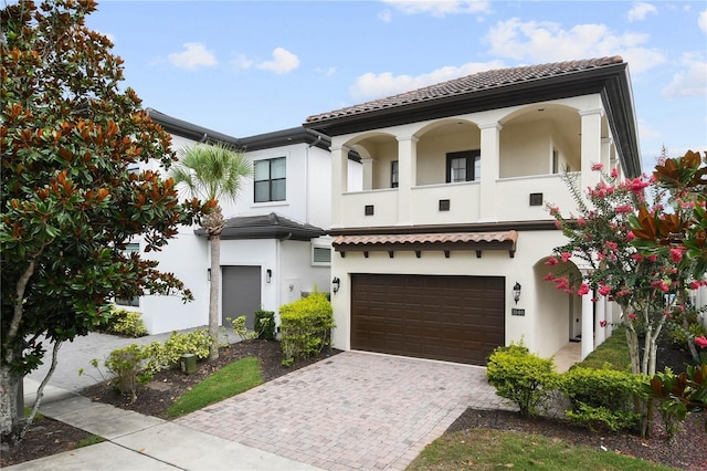 mediterranean / spanish home featuring a garage