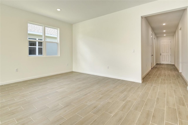 spare room with light hardwood / wood-style flooring