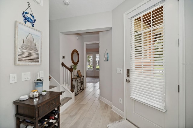 foyer with light hardwood / wood-style floors and french doors