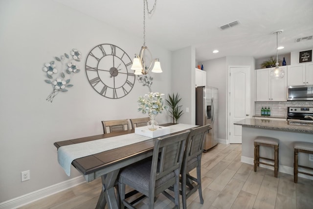 dining space featuring an inviting chandelier