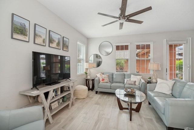 living room featuring ceiling fan and light hardwood / wood-style flooring