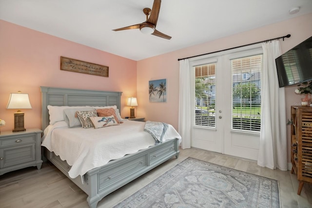 bedroom with access to exterior, french doors, and ceiling fan