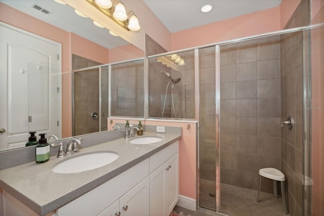 bathroom featuring vanity and a shower with shower door