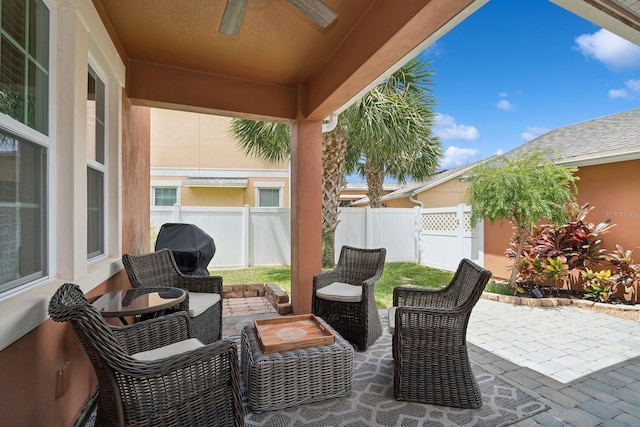 view of patio with area for grilling and ceiling fan