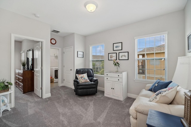 sitting room featuring light colored carpet