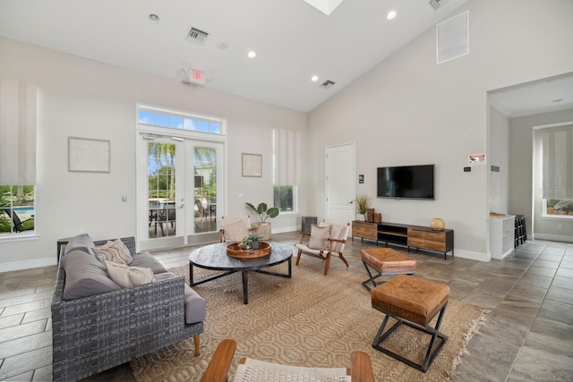 living room featuring high vaulted ceiling and french doors