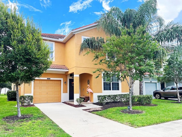 mediterranean / spanish-style home featuring a front yard and a garage