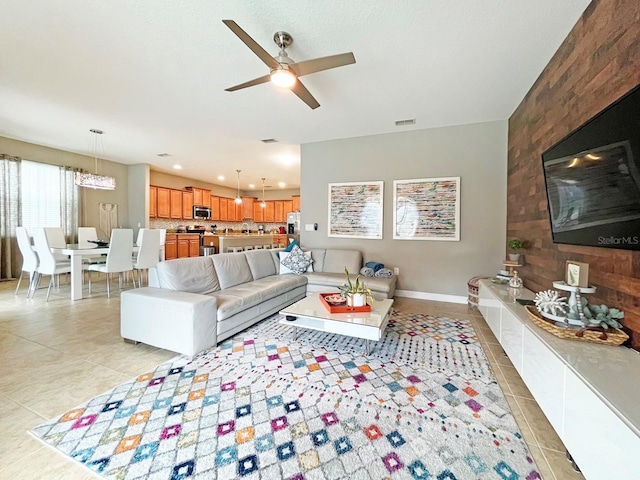 living room featuring ceiling fan and light tile patterned flooring