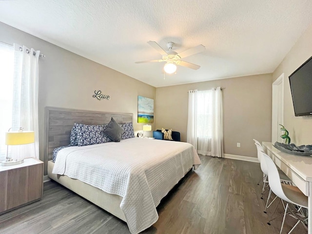 bedroom featuring a textured ceiling, ceiling fan, and dark wood-type flooring