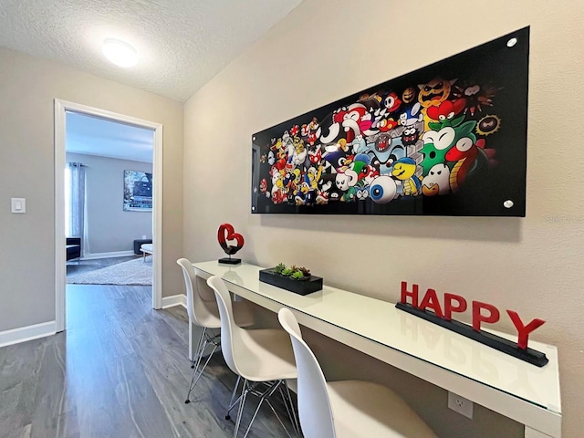 interior space with a textured ceiling and hardwood / wood-style flooring