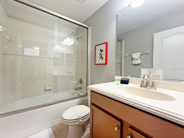 full bathroom with vanity, tile patterned flooring, toilet, enclosed tub / shower combo, and a textured ceiling