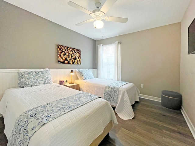 bedroom featuring ceiling fan and dark wood-type flooring