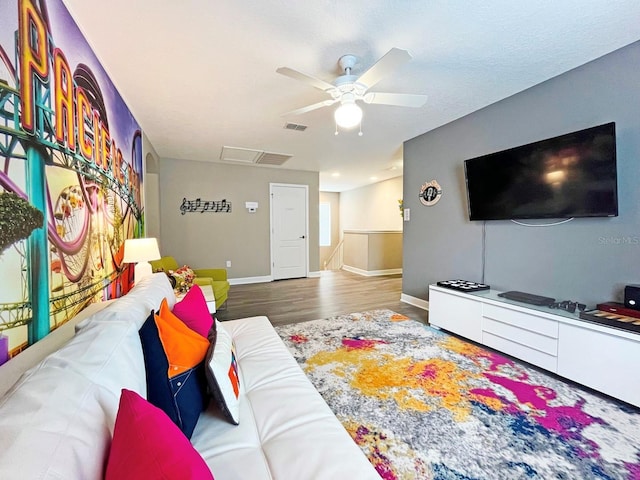 living room with hardwood / wood-style floors and ceiling fan