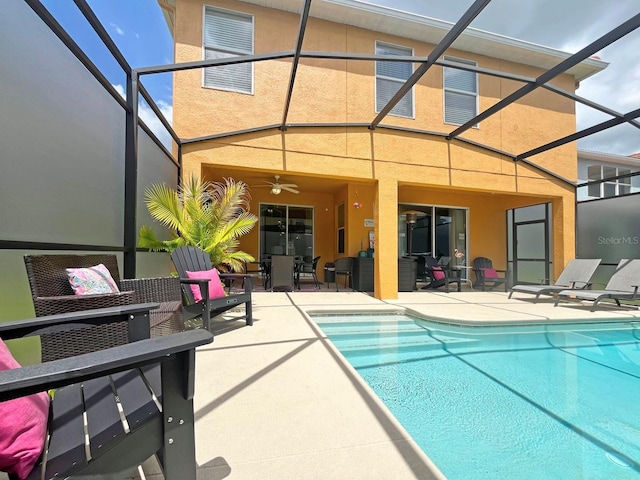 view of pool featuring ceiling fan, a lanai, and a patio