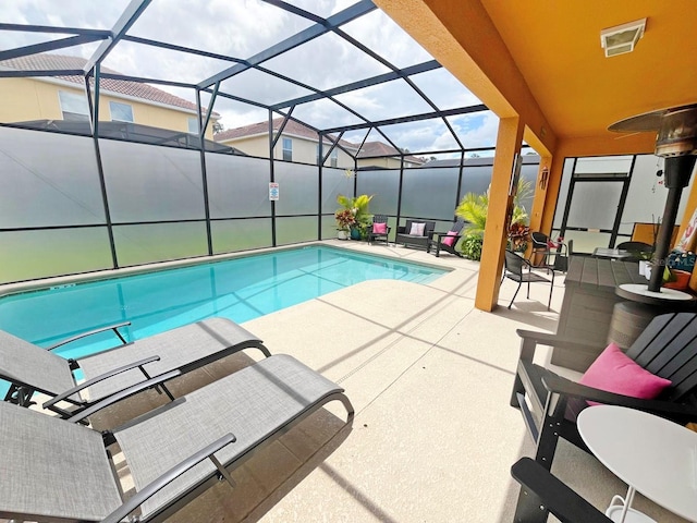 view of swimming pool with a lanai and a patio