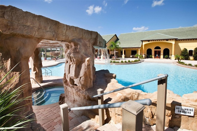 view of swimming pool with a community hot tub