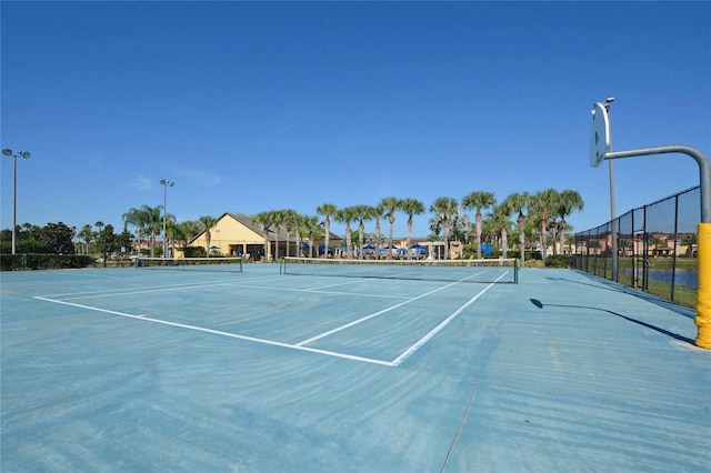 view of tennis court featuring basketball hoop