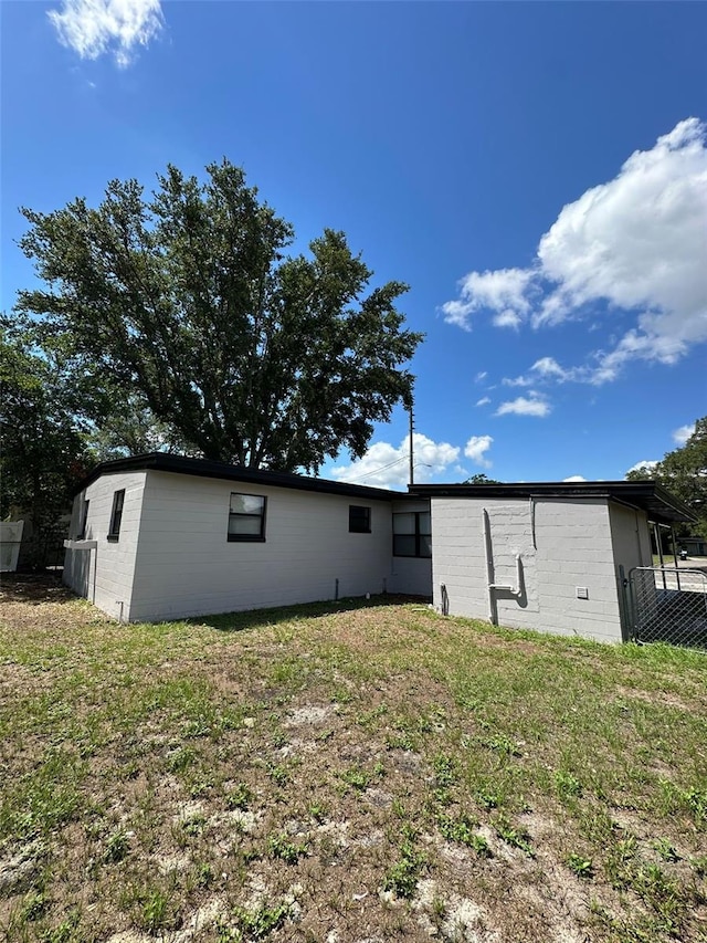 rear view of property with a lawn