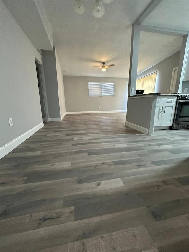 unfurnished living room with ceiling fan and hardwood / wood-style flooring