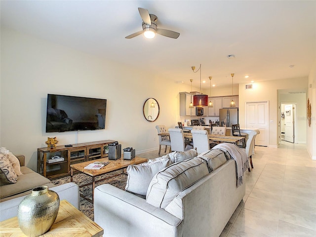 living room with ceiling fan and light tile floors