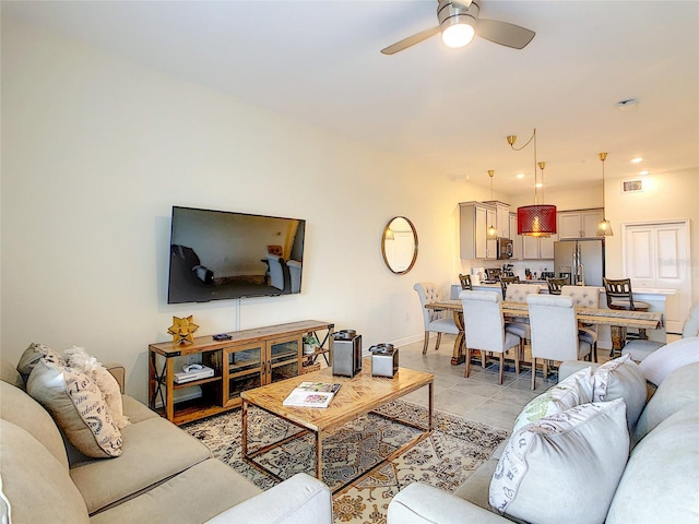 tiled living room with ceiling fan