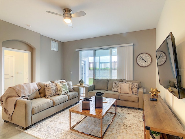 living room featuring tile floors and ceiling fan