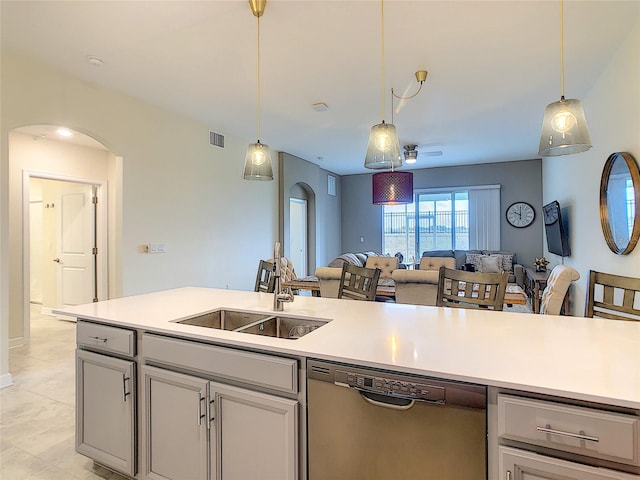 kitchen with decorative light fixtures, gray cabinetry, stainless steel dishwasher, sink, and light tile floors