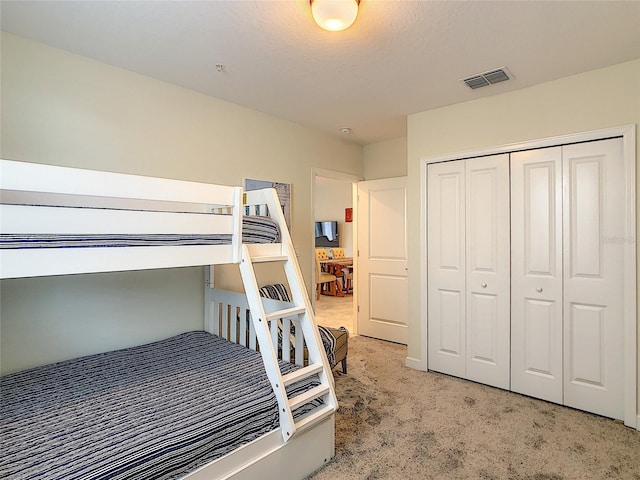 bedroom featuring a closet and carpet floors