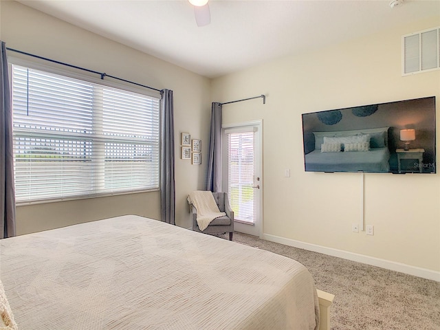 bedroom with carpet, ceiling fan, access to outside, and multiple windows