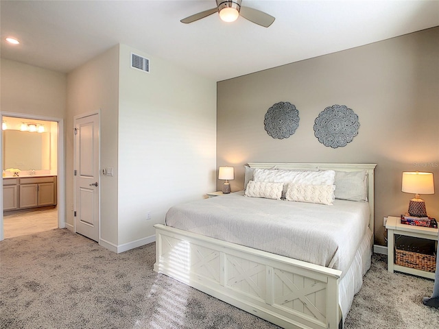 carpeted bedroom featuring ensuite bathroom and ceiling fan