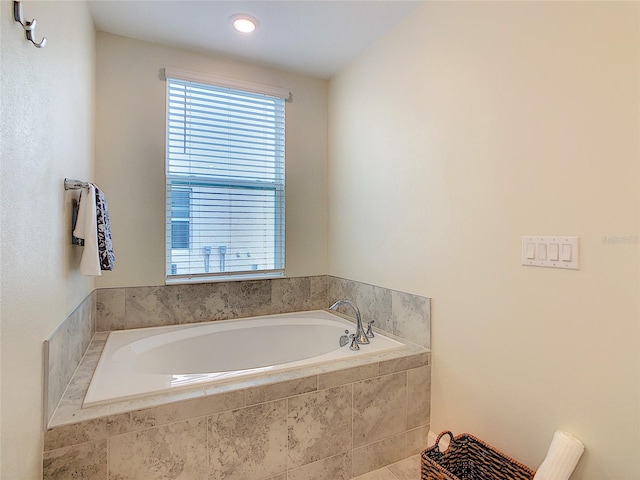 bathroom with tiled bath