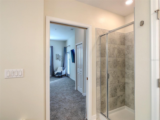 bathroom featuring a shower with door