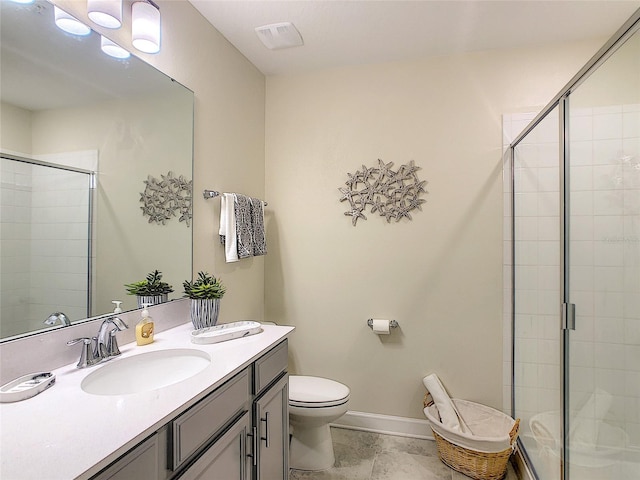 bathroom featuring a shower with shower door, tile flooring, vanity, and toilet