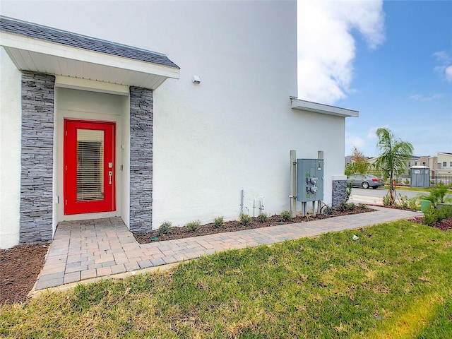 entrance to property with a lawn