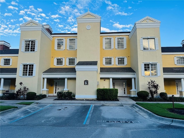 view of property with uncovered parking