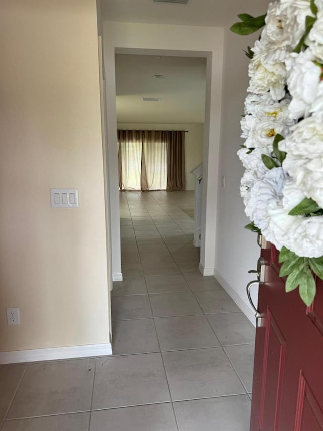 corridor with light tile patterned floors