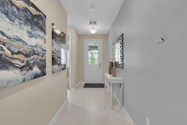 doorway with light tile patterned flooring