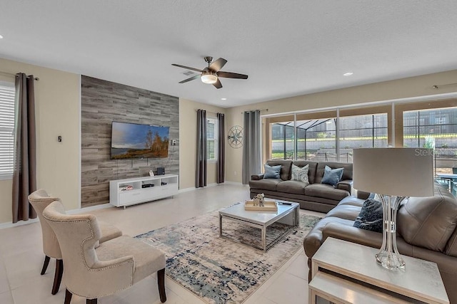 living room featuring ceiling fan and light tile patterned floors