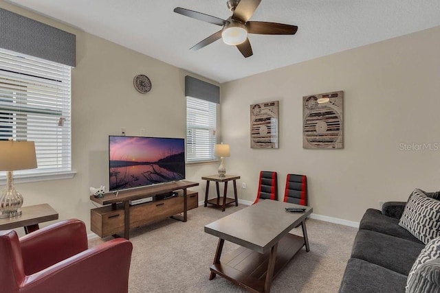 carpeted living room featuring ceiling fan