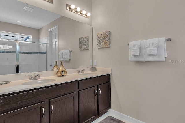 bathroom with walk in shower and vanity