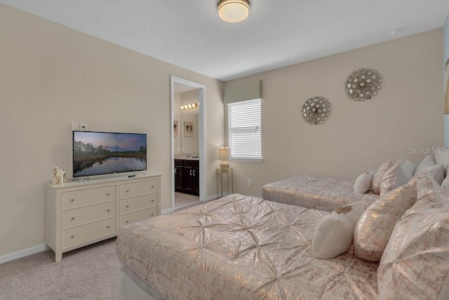 carpeted bedroom with ensuite bath