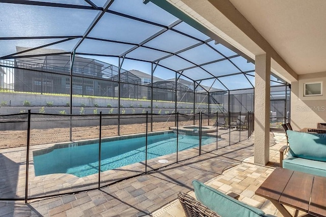 view of swimming pool featuring an in ground hot tub, glass enclosure, and a patio area