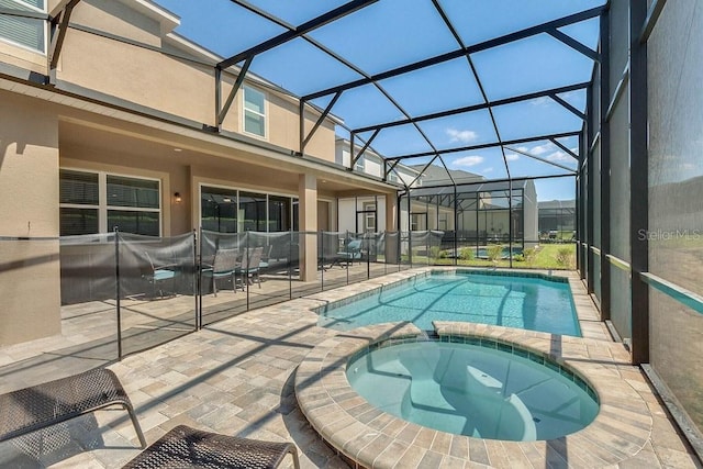 view of swimming pool featuring an in ground hot tub, a lanai, and a patio area